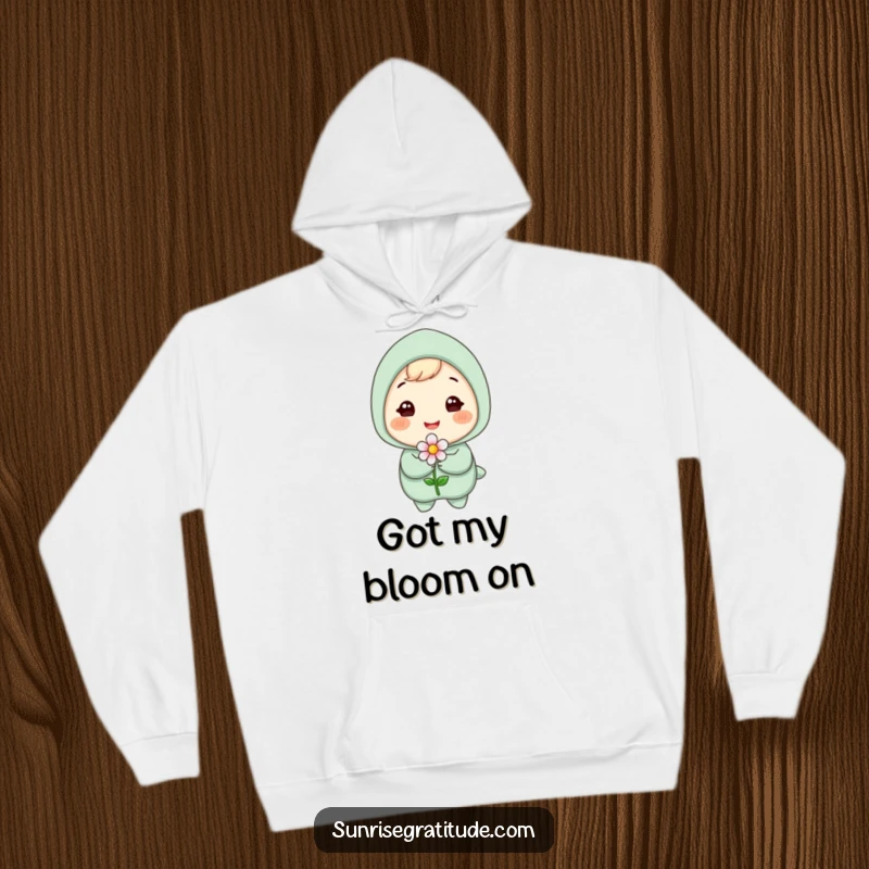Funny hoodie featuring a gleeful character with a radiant smile, tenderly holding a small blooming flower, exuding warmth and happiness.