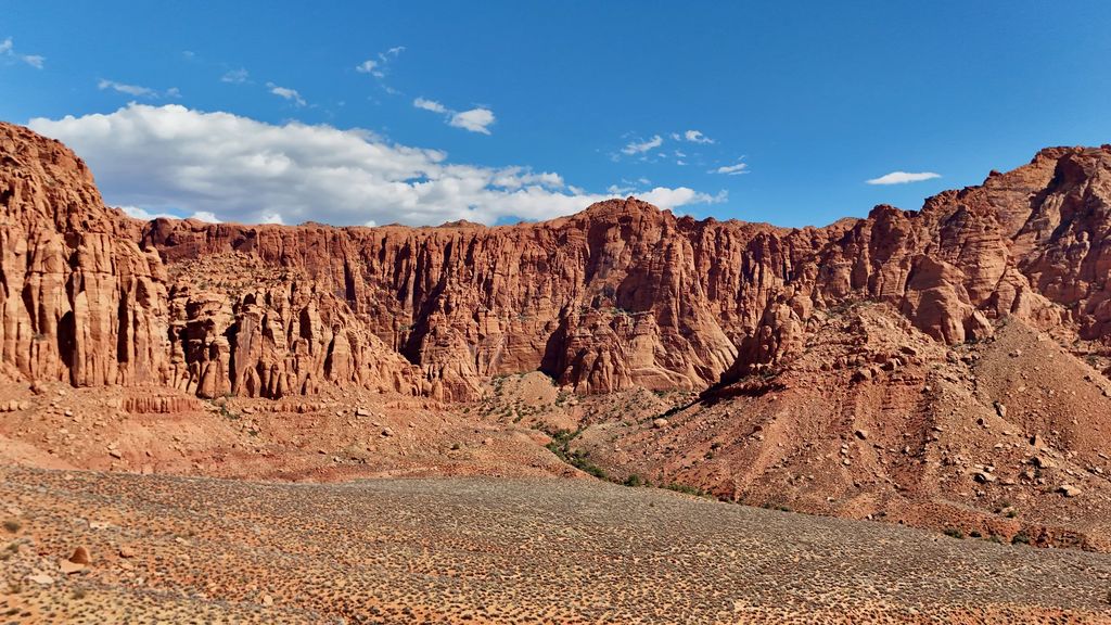 Red sandstone cliffs under white clouds near Ivins, Utah